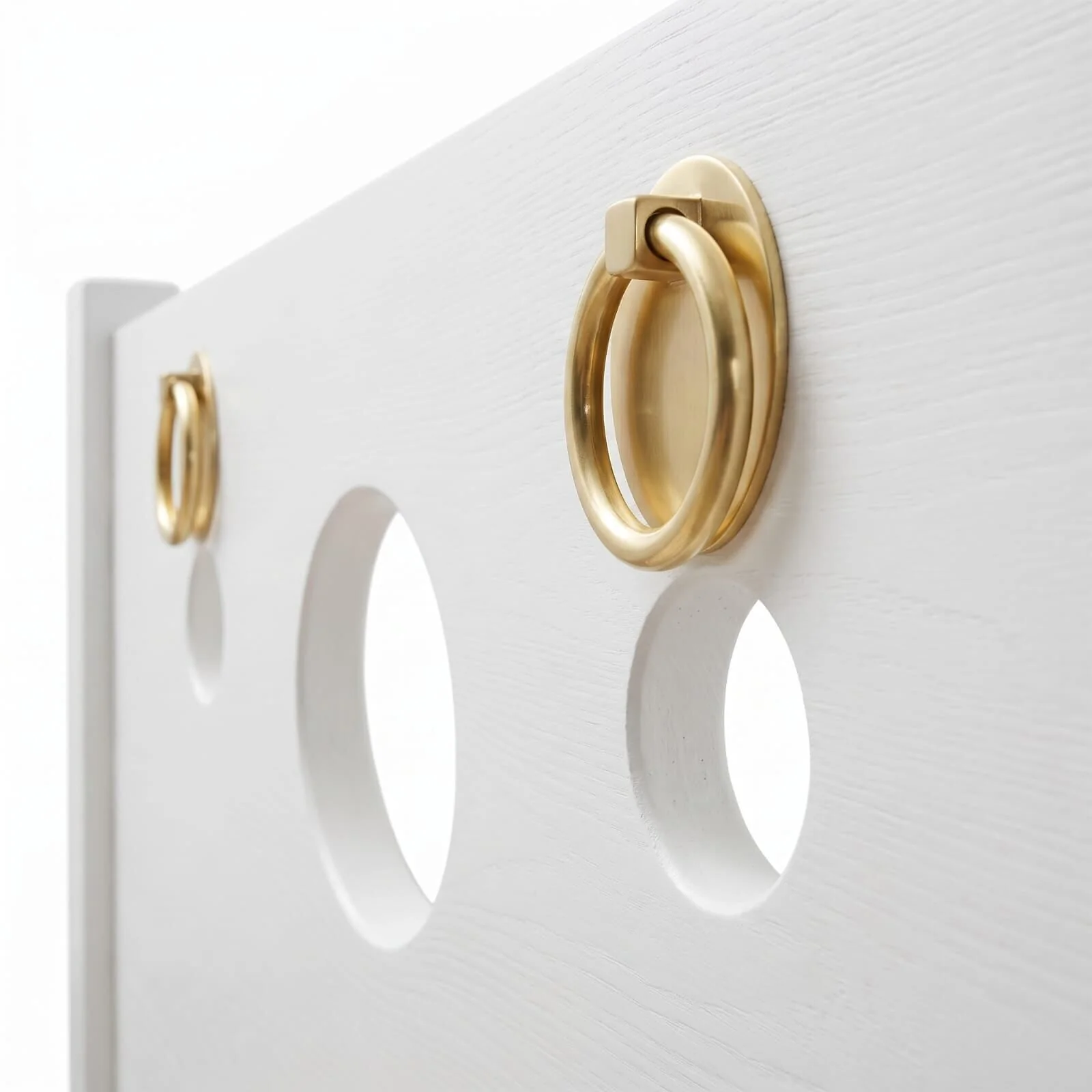 Close-up of the Alabaster White panel: a gold-tone ring and round cut-outs