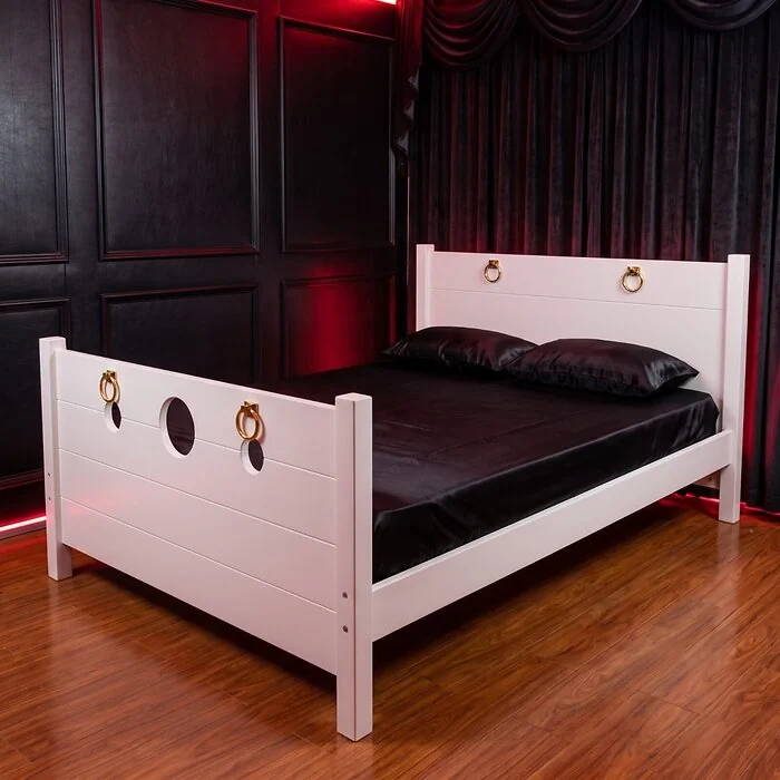 The Sovereign Bed in Alabaster White in a red-panelled bedroom on a wooden floor