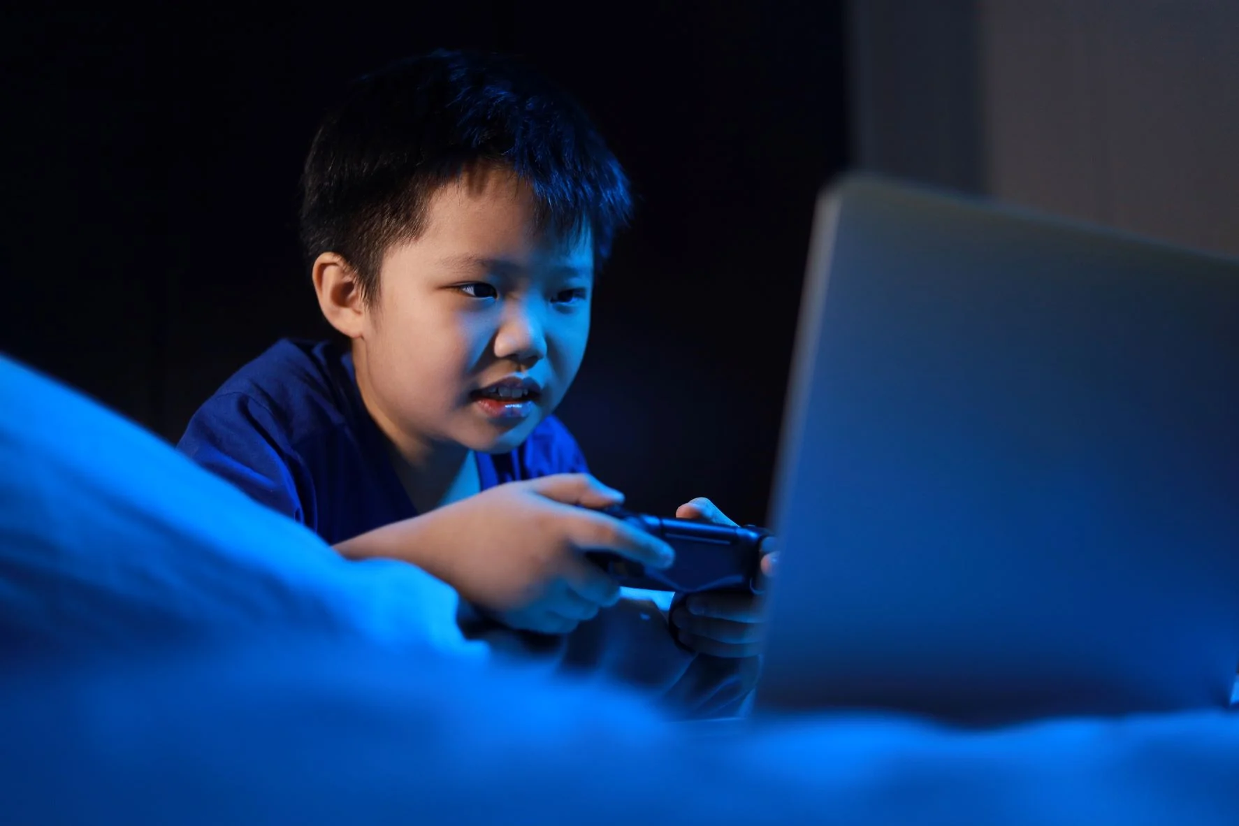 Child on video game at night
