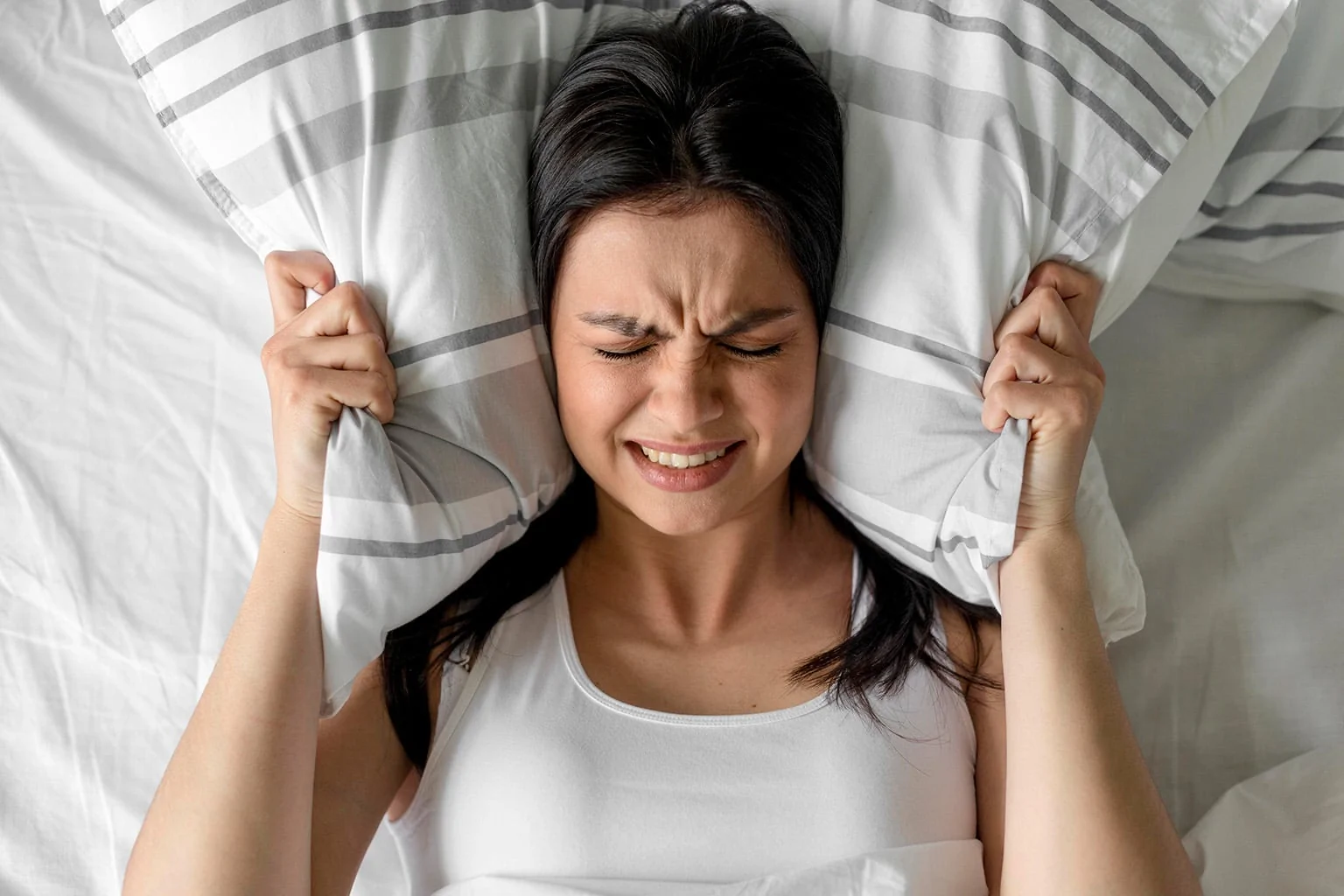 Top view young woman holding pillow bed